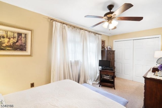 bedroom with a closet, carpet flooring, and ceiling fan