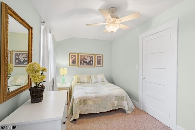 bedroom with carpet flooring, vaulted ceiling, and ceiling fan