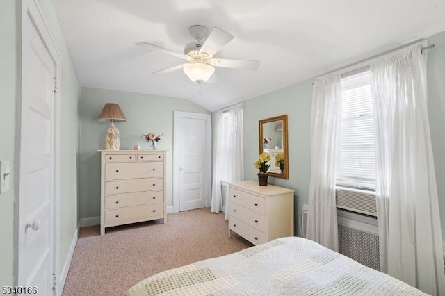 bedroom featuring light carpet, baseboards, vaulted ceiling, and a ceiling fan