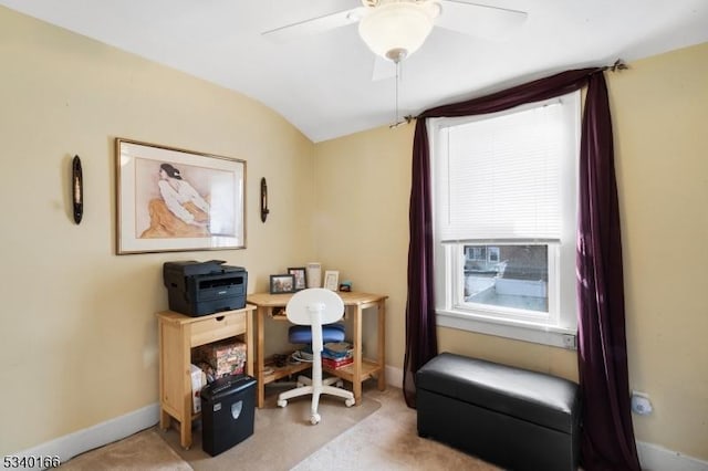 home office featuring vaulted ceiling, ceiling fan, light carpet, and baseboards