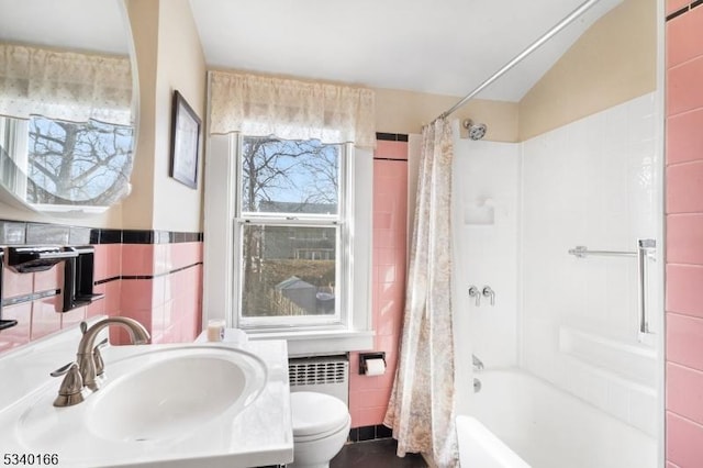 bathroom with shower / bathtub combination with curtain, plenty of natural light, tile walls, and toilet