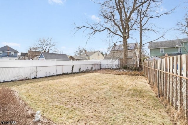 view of yard with a residential view and a fenced backyard