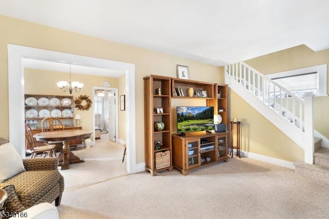 living room featuring carpet, stairs, a chandelier, and baseboards