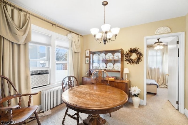 dining room with light colored carpet, radiator heating unit, an inviting chandelier, cooling unit, and baseboards