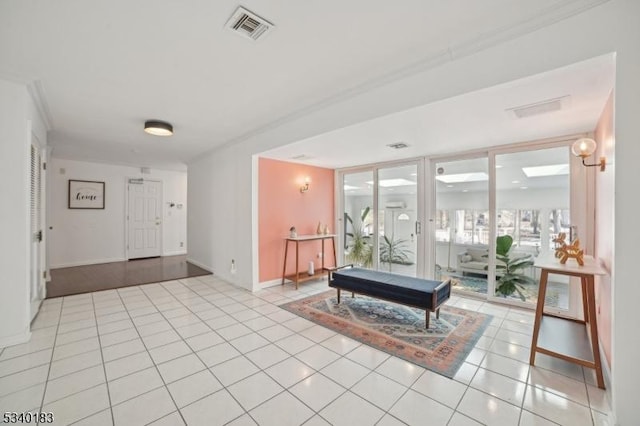 interior space with light tile patterned floors, floor to ceiling windows, visible vents, and baseboards