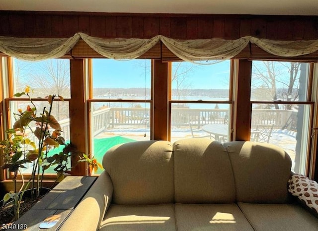 sunroom / solarium with a water view