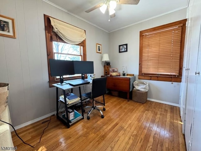 office area with baseboards, ceiling fan, light wood-type flooring, and crown molding