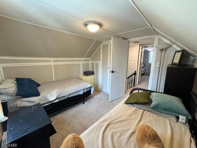 bedroom featuring carpet and vaulted ceiling