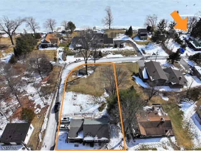 snowy aerial view with a residential view