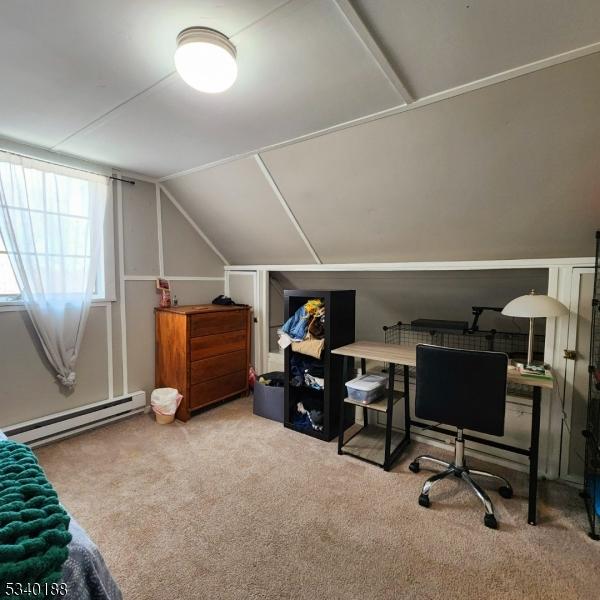 office with vaulted ceiling, baseboard heating, and carpet