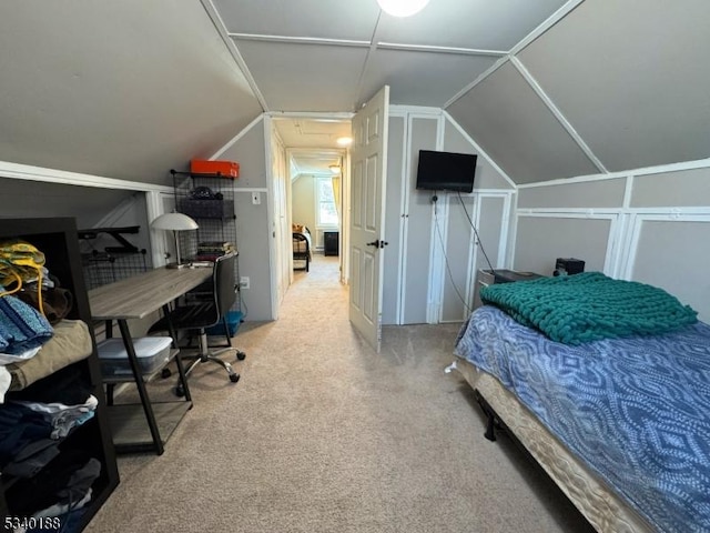 carpeted bedroom featuring lofted ceiling