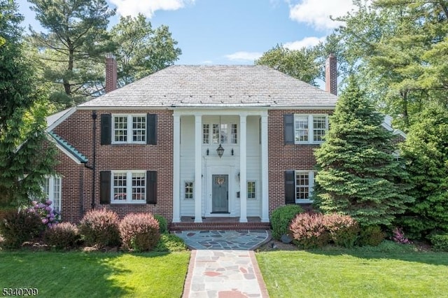 75 Crest Dr, South Orange Village Twp, NJ 07079 - greek revival house with a chimney, a front lawn, and brick siding