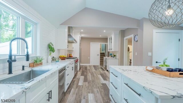 75 Crest Dr, South Orange Village Twp, NJ 07079 - kitchen with a sink, wall chimney range hood, vaulted ceiling, light wood-style flooring, and white cabinetry