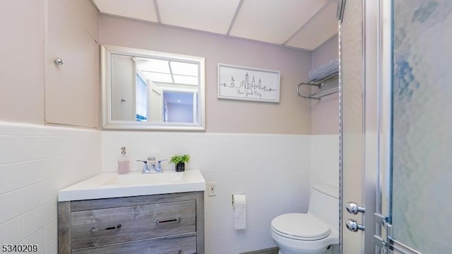 75 Crest Dr, South Orange Village Twp, NJ 07079 - bathroom with vanity, tile walls, toilet, and a wainscoted wall