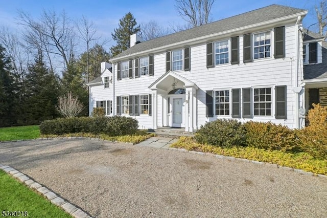 colonial home featuring a chimney