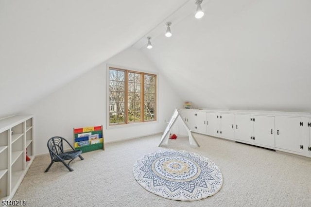 recreation room with lofted ceiling and light colored carpet