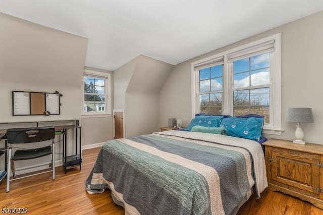 bedroom with wood finished floors and baseboards