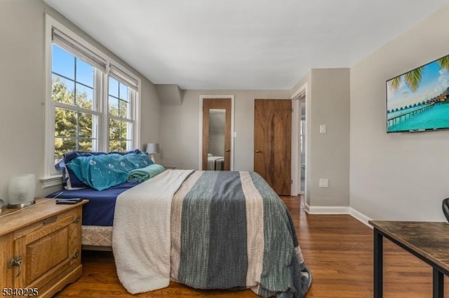 bedroom with baseboards and wood finished floors