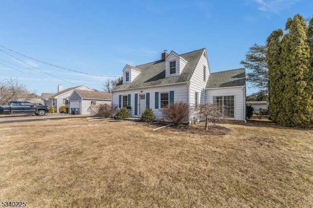 new england style home with a front yard and a chimney