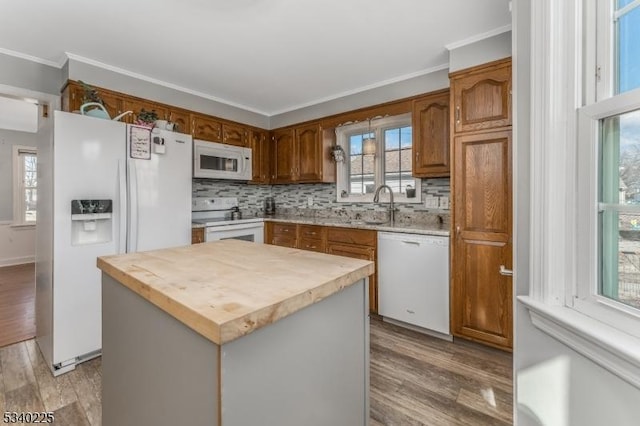 kitchen with ornamental molding, wooden counters, white appliances, and light wood-style floors