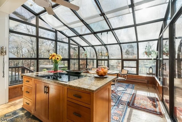 sunroom / solarium featuring lofted ceiling