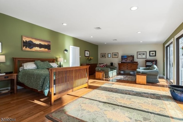 bedroom with visible vents, wood finished floors, and recessed lighting