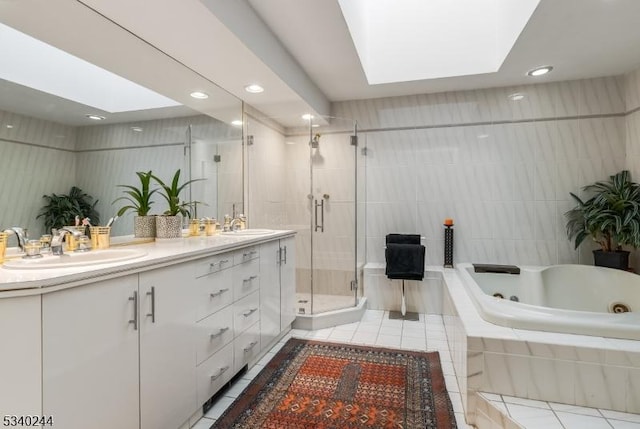 bathroom featuring a stall shower, a skylight, and tile patterned flooring