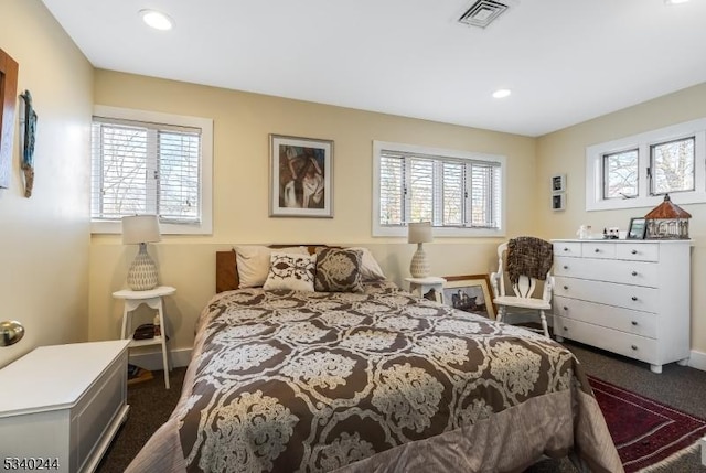 bedroom featuring recessed lighting, multiple windows, dark carpet, and visible vents