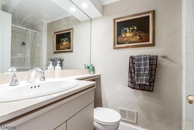 bathroom featuring toilet, curtained shower, vanity, and visible vents