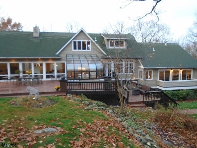 back of house with a deck