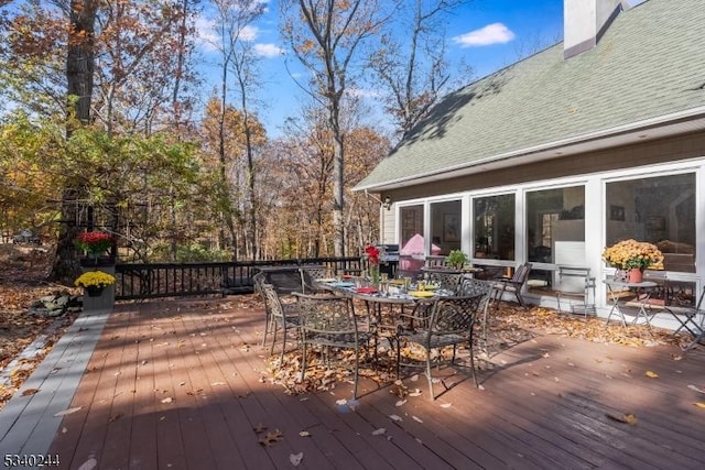 wooden deck featuring outdoor dining area