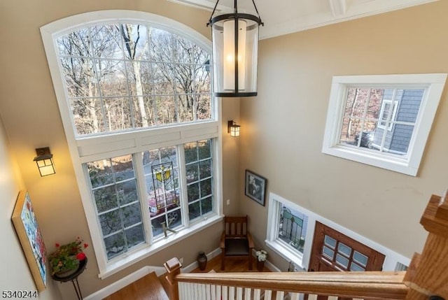 stairs with plenty of natural light and baseboards