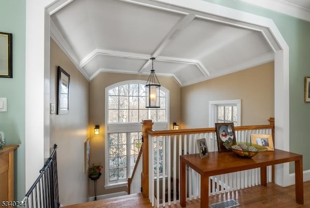 corridor featuring lofted ceiling, visible vents, and an upstairs landing