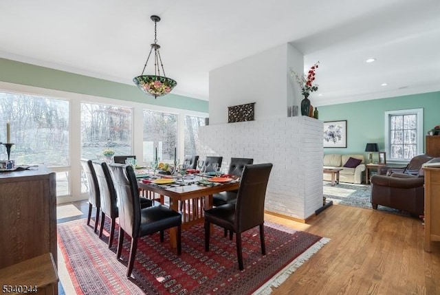 dining room featuring ornamental molding, recessed lighting, and light wood finished floors