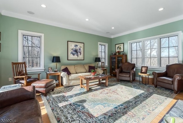 living room with recessed lighting, crown molding, baseboards, and wood finished floors