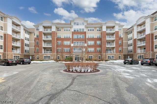 view of building exterior with uncovered parking