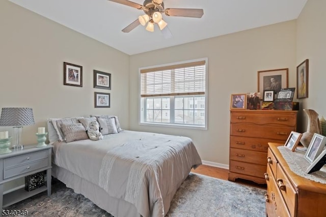 bedroom featuring ceiling fan and baseboards