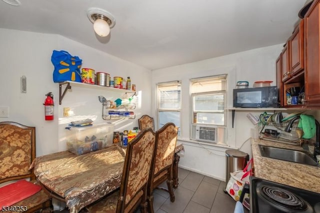 dining space with cooling unit and dark tile patterned flooring