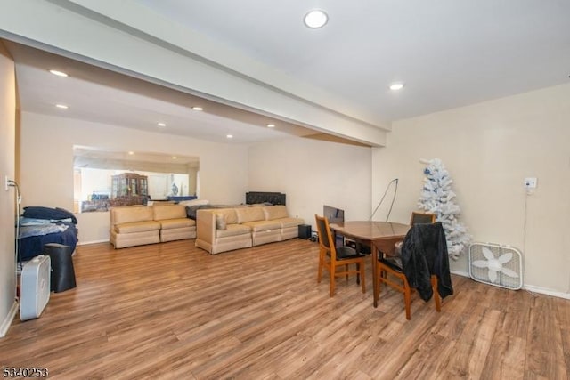 dining space with light wood-style flooring, baseboards, beam ceiling, and recessed lighting