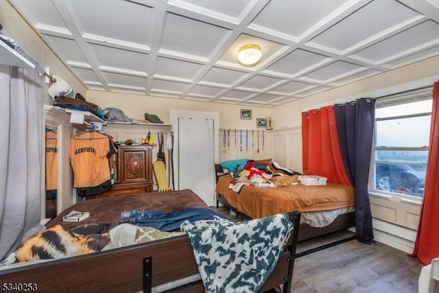 bedroom featuring coffered ceiling and dark wood finished floors