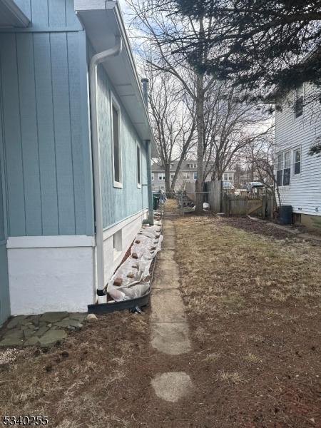 view of side of property featuring fence