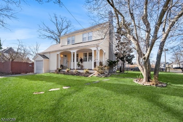 view of front of property with a front lawn, a garage, fence, and covered porch