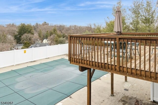 exterior space with a patio area, fence, and a wooden deck