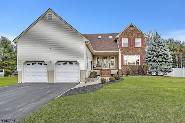 view of front of home featuring driveway, an attached garage, covered porch, a front lawn, and brick siding