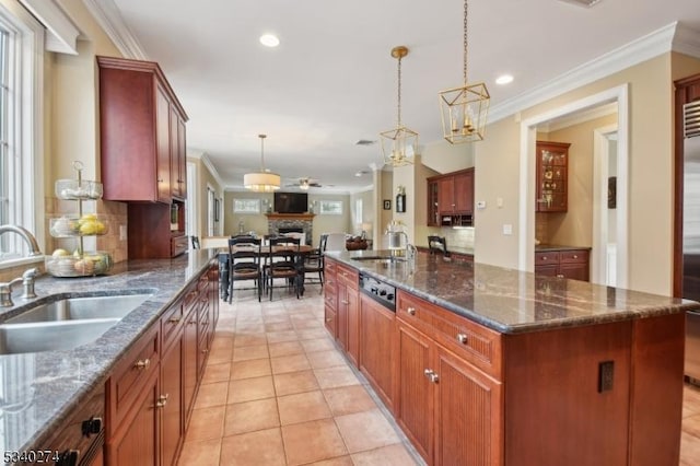 kitchen with open floor plan, ornamental molding, and a sink