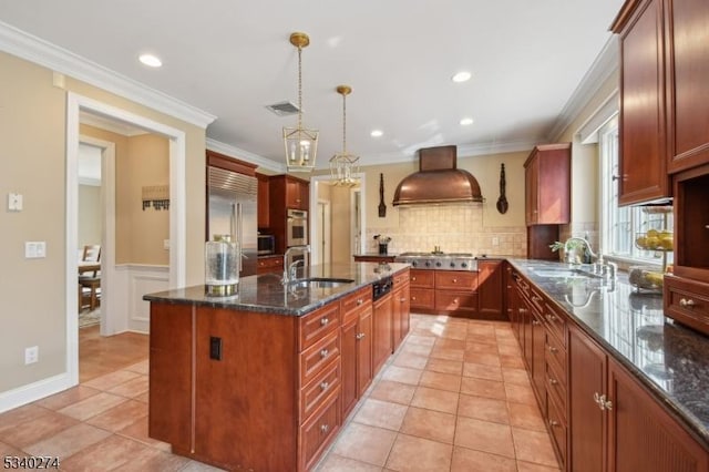 kitchen featuring custom range hood, visible vents, stainless steel appliances, and a sink