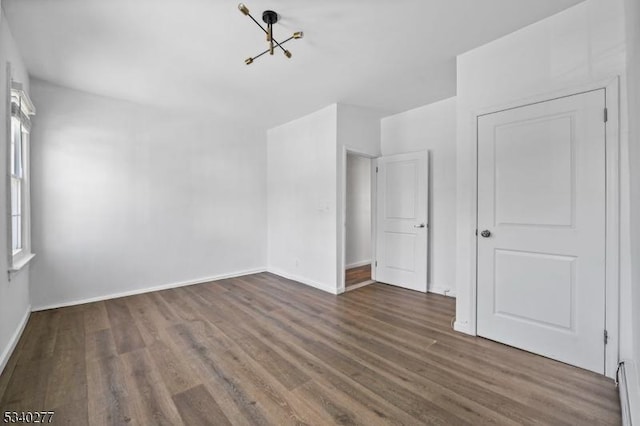 spare room featuring wood finished floors and baseboards