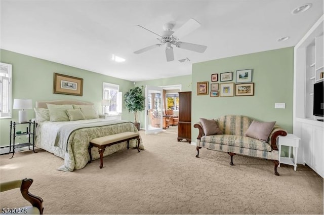 carpeted bedroom with visible vents and ceiling fan