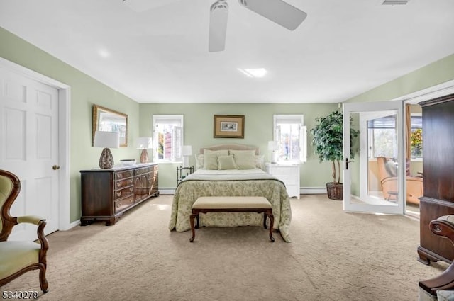 bedroom featuring a ceiling fan, a baseboard radiator, light carpet, and baseboards