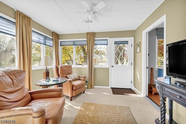 sunroom / solarium with a ceiling fan